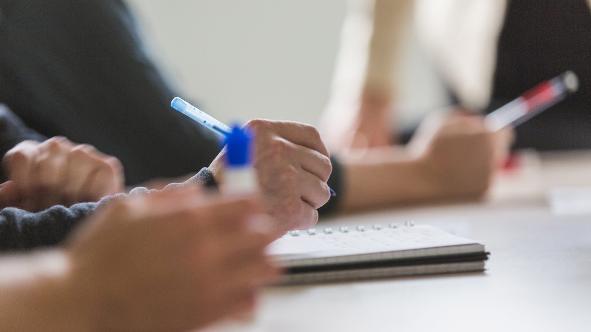 Team taking meeting notes 4460x4460