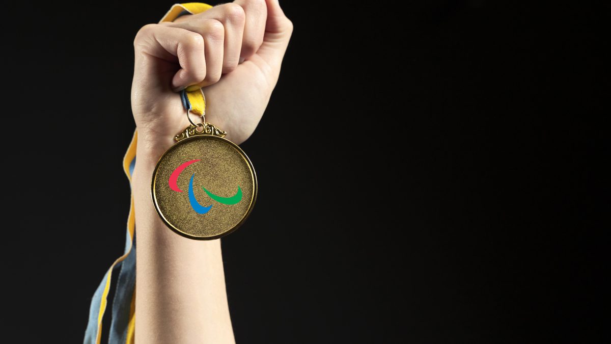 Athlete holding gold medal closeupv2